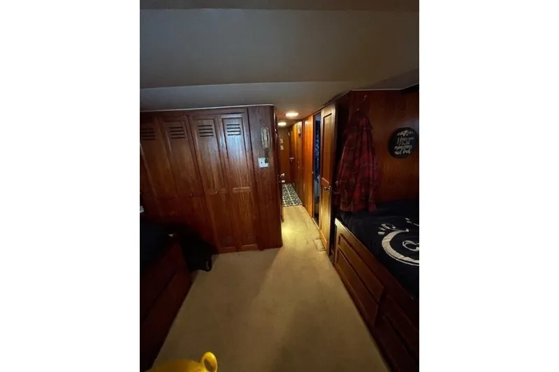 Slide: The Image of Interior of 1978 Hatteras 53 Motor Yacht with wooden cabinetry and cozy hallway. - 57