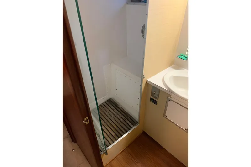 Slide: The Image of 1978 Hatteras 53 Motor Yacht cabin with wood paneling and floral bedding. - 59