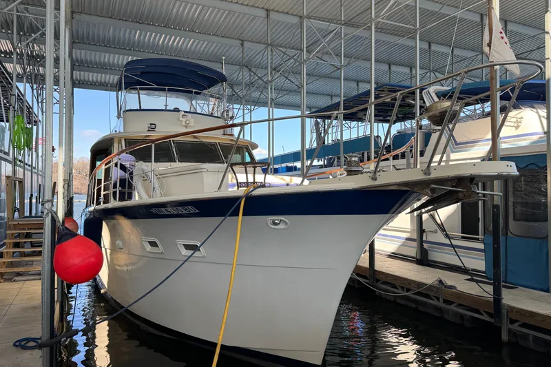 Slide: The Image of 1978 Hatteras 53 Motor Yacht docked in a covered marina. - 6