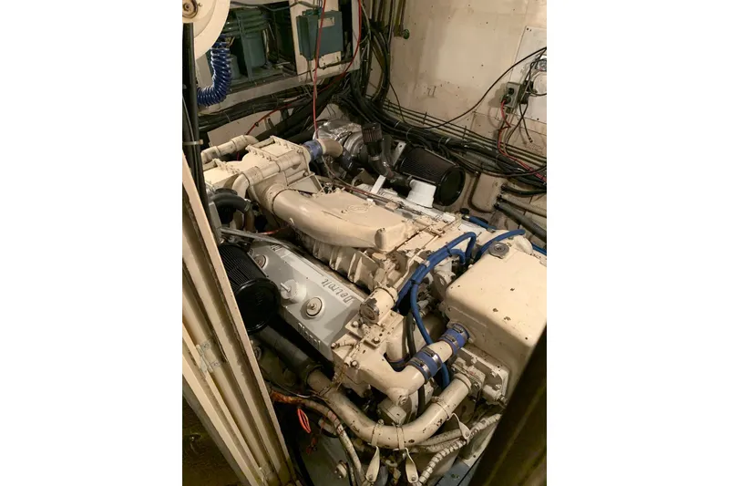 Slide: The Image of Narrow hallway inside 1978 Hatteras 53 Motor Yacht with patterned carpet and closed door. - 64