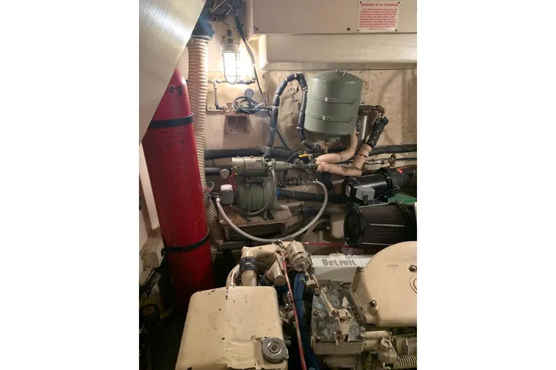 Slide: The Image of Engine room of a 1978 Hatteras 53 Motor Yacht, showcasing mechanical components. - 69