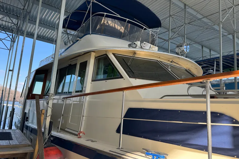 Slide: The Image of 1978 Hatteras 53 Motor Yacht docked under a metal canopy. - 7