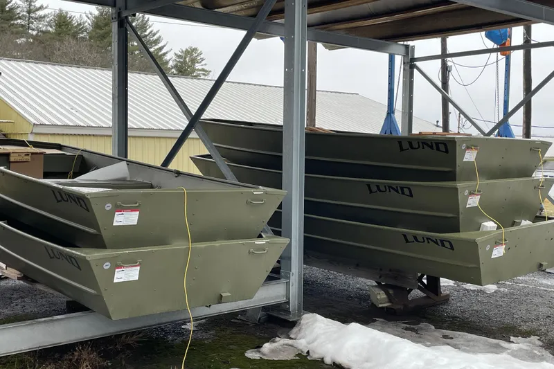 Slide: The Image of Stacked 2026 Lund 1648M boats in storage, showcasing durable design and construction. - 3