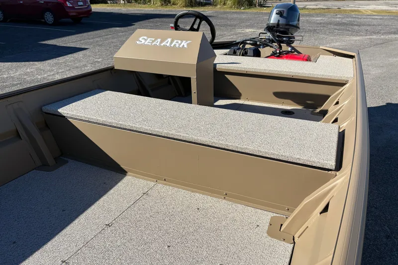 Slide: The Image of 2026 SeaArk 1648 MV boat interior with seating and steering console. - 13