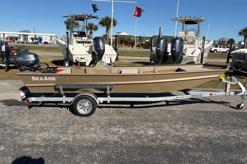Slide: The Image of 2026 SeaArk 1648 MV boat on trailer, displayed outdoors with other boats. - 4