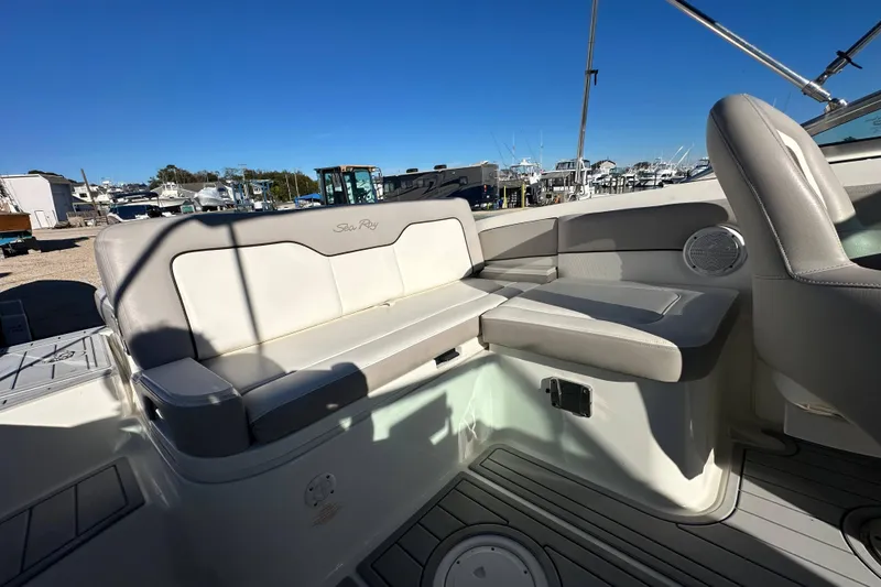 Slide: The Image of 2011 Sea Ray 240 Sundeck interior with cushioned seating and sleek design. - 10