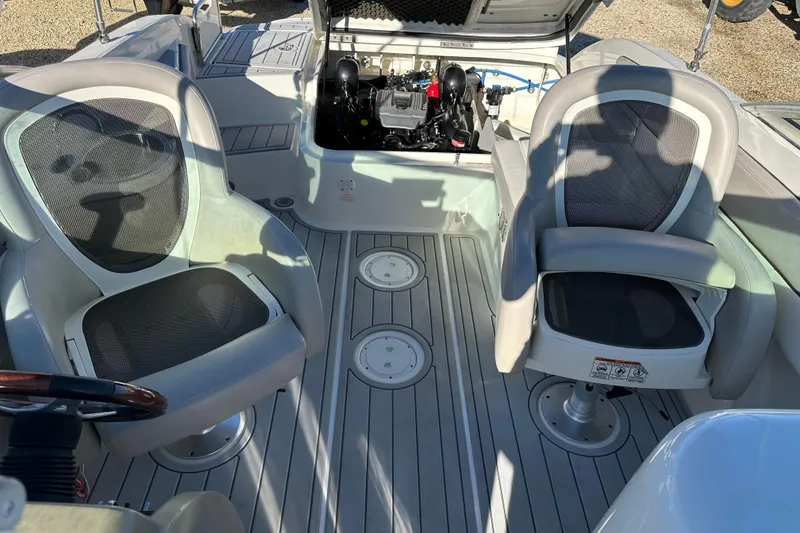Slide: The Image of 2011 Sea Ray 240 Sundeck interior with open engine compartment and seating. - 8