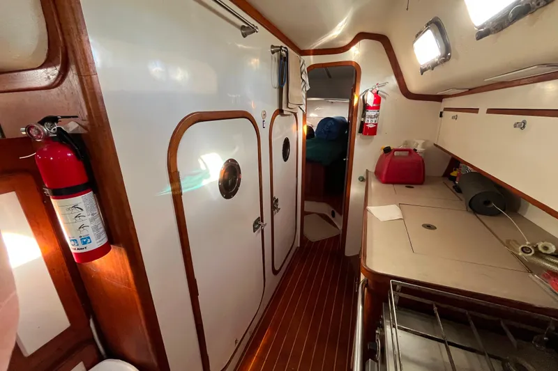 Slide: The Image of Interior of 1985 Caliber 47LRC yacht with wooden accents and safety equipment. - 11