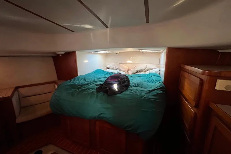 Slide: The Image of Cozy cabin interior of 1985 Caliber 47LRC yacht with bed and helmet. - 12