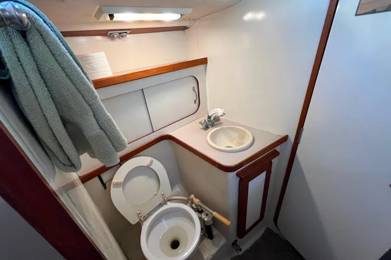 Slide: The Image of Compact bathroom in 1985 Caliber 47LRC yacht with sink, toilet, and storage. - 16