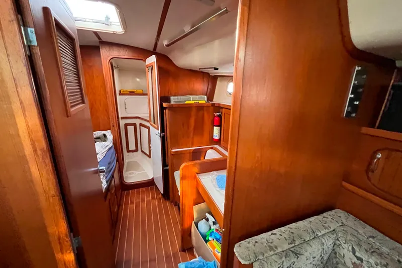 Slide: The Image of Interior of 1985 Caliber 47LRC yacht with wooden finish and cozy cabin space. - 18