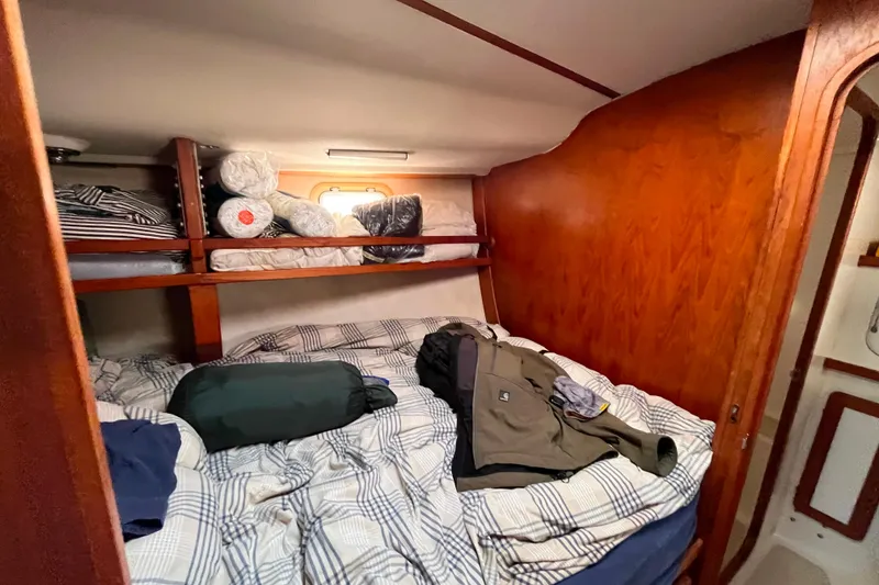 Slide: The Image of Cozy cabin interior of 1985 Caliber 47LRC sailboat with bed and storage shelves. - 20