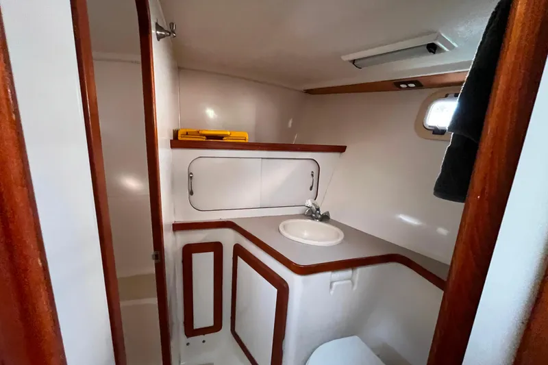 Slide: The Image of Bathroom interior of 1985 Caliber 47LRC yacht with sink and wooden accents. - 21