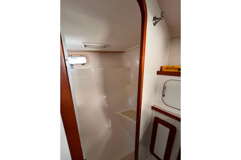 Slide: The Image of 1985 Caliber 47LRC yacht bathroom with wooden trim and compact design. - 22