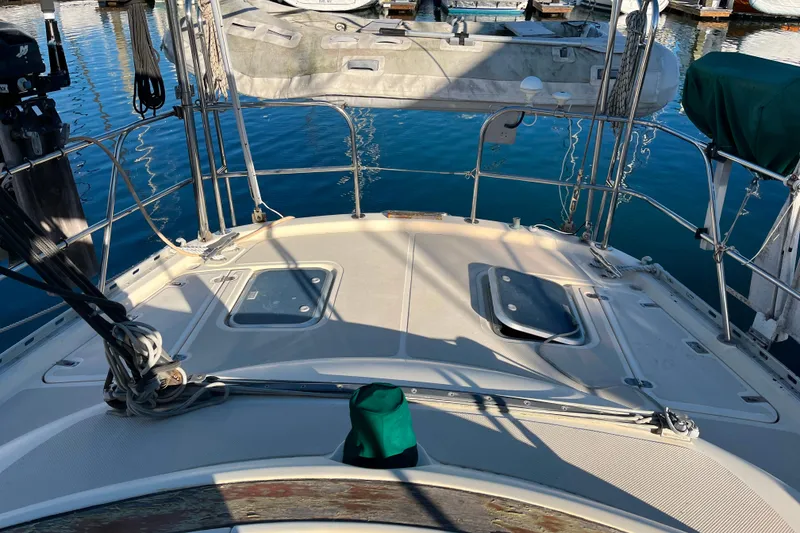 Slide: The Image of 1985 Caliber 47LRC yacht deck with hatches, docked in marina. - 3