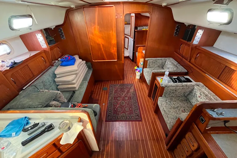 Slide: The Image of Interior of 1985 Caliber 47LRC yacht with wooden furnishings and cozy seating area. - 8