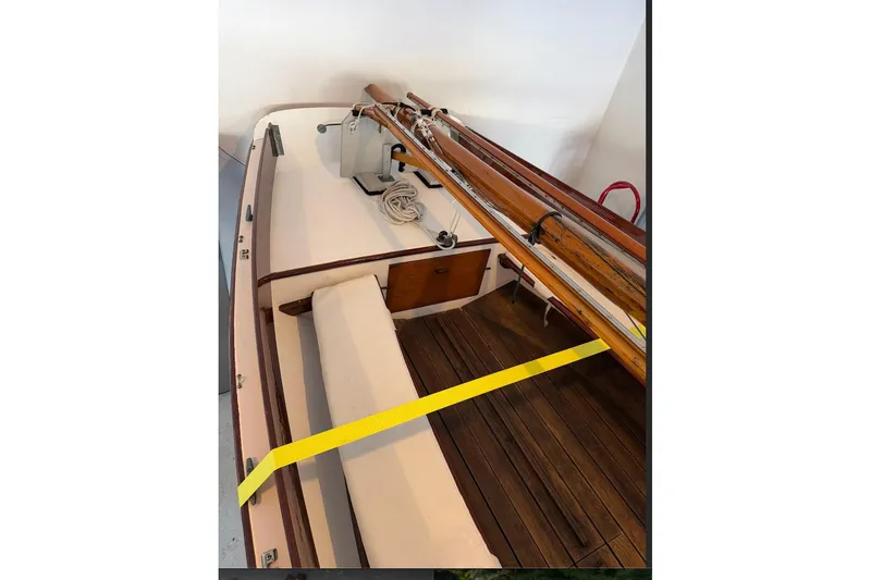 Slide: The Image of 2002 Herreshoff 12 1/2 sailboat interior with wooden deck and mast. - 14