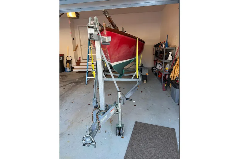 Slide: The Image of Herreshoff 12 1/2 sailboat from 2002 on a trailer in a garage. - 15