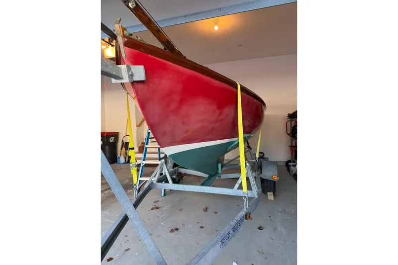 Slide: The Image of Red Herreshoff 12 1/2 sailboat from 2002 on trailer in garage. - 16