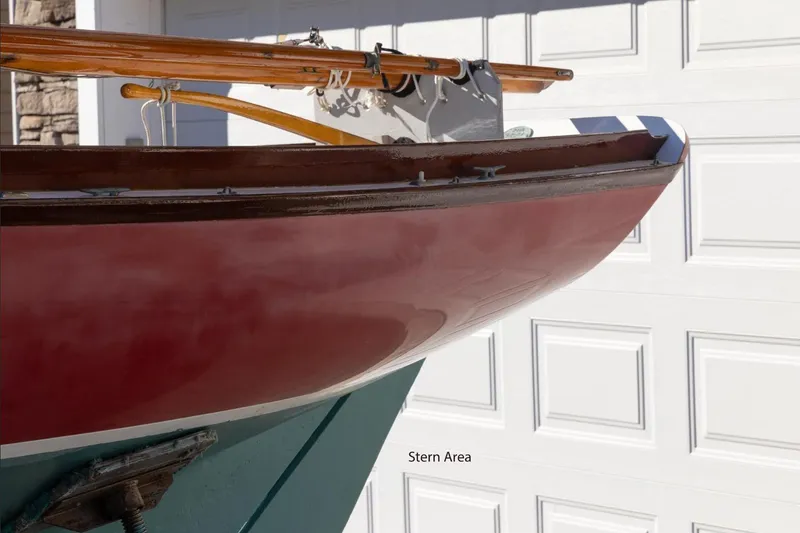 Slide: The Image of Cape Cod Shipbuilding Herreshoff 12, 2002 model, stern area detail against garage backdrop. - 3