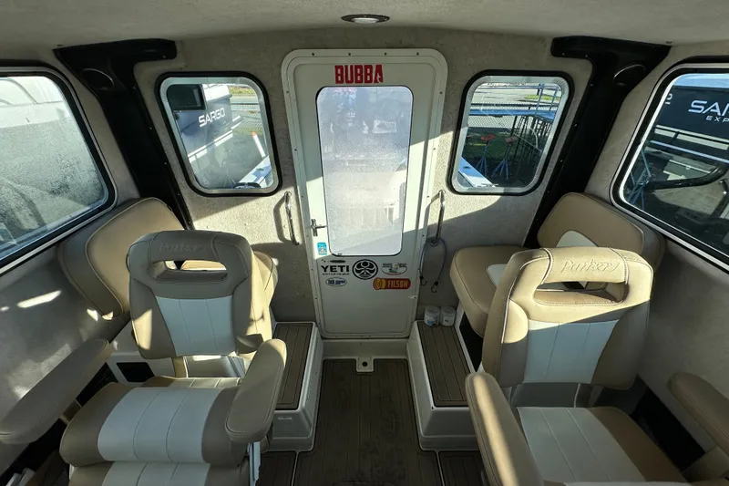 Slide: The Image of Interior of 2019 Parker 2820 XLD Sport Cabin with beige seating and door. - 24