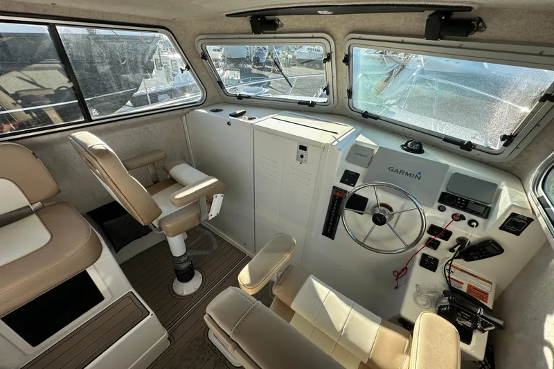 Slide: The Image of 2019 Parker 2820 XLD Sport Cabin interior with steering wheel and Garmin navigation system. - 25