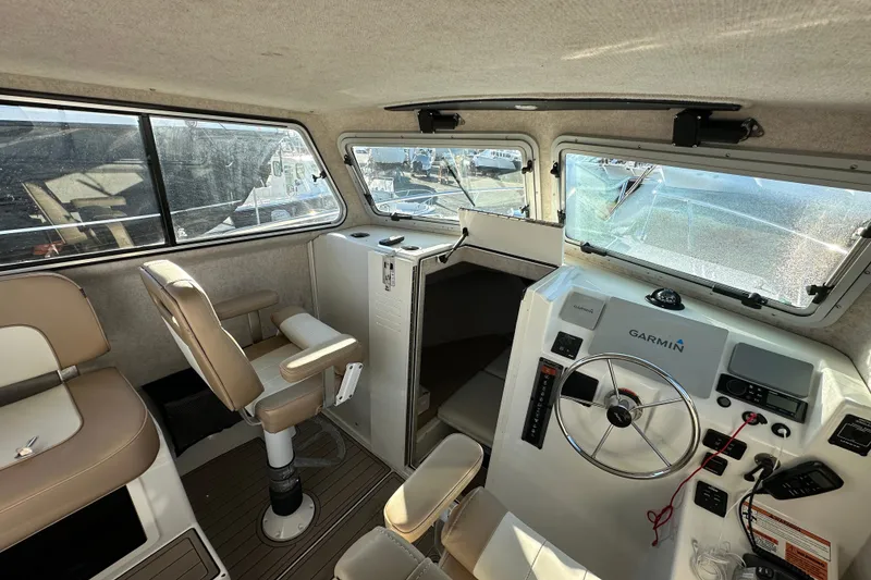 Slide: The Image of 2019 Parker 2820 XLD Sport Cabin interior with helm, seating, and Garmin navigation system. - 26