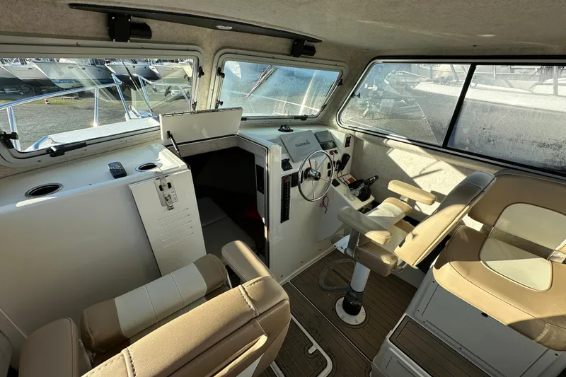 Slide: The Image of 2019 Parker 2820 XLD Sport Cabin interior with helm and seating. - 27