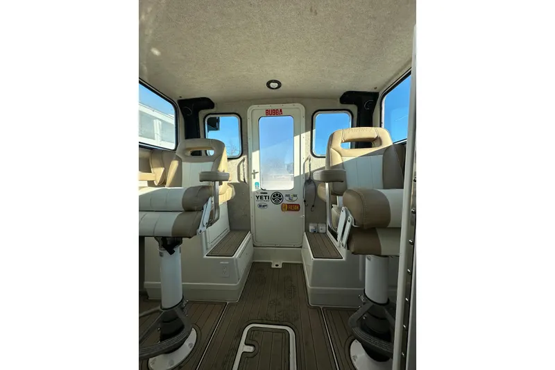 Slide: The Image of Interior of 2019 Parker 2820 XLD Sport Cabin with beige seating and wood flooring. - 28