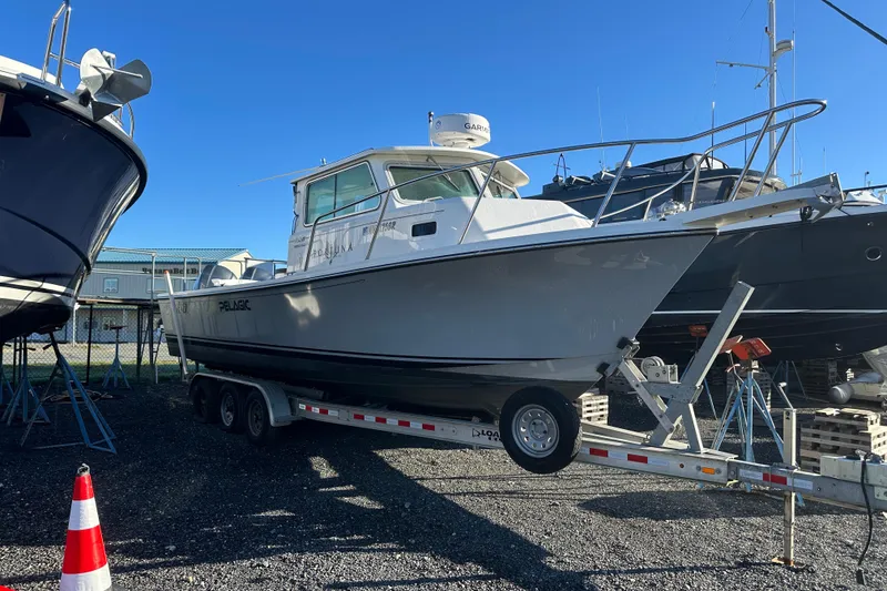 Slide: The Image of 2019 Parker 2820 XLD Sport Cabin boat on trailer in marina. - 7