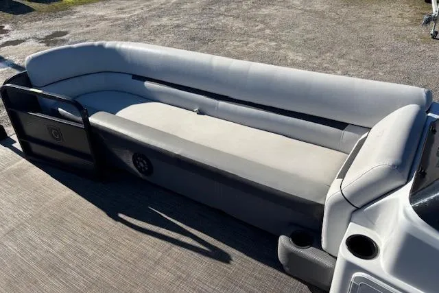 Slide: The Image of 2022 Sweetwater 2286 pontoon boat with spacious gray seating and cup holders. - 10