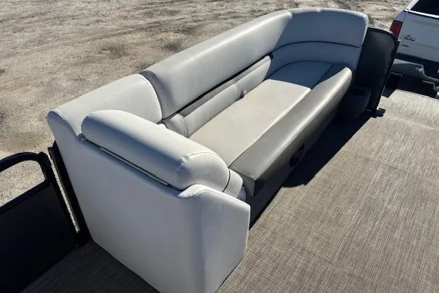 Slide: The Image of 2022 Sweetwater 2286 boat interior with gray cushioned seating on deck. - 11