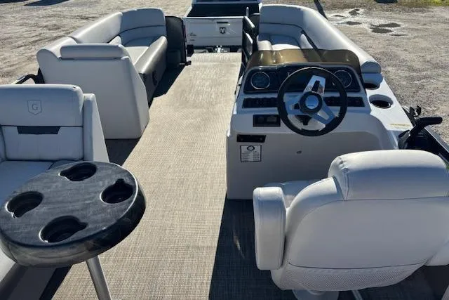 Slide: The Image of 2022 Sweetwater 2286 pontoon boat interior with plush seating and modern dashboard. - 16