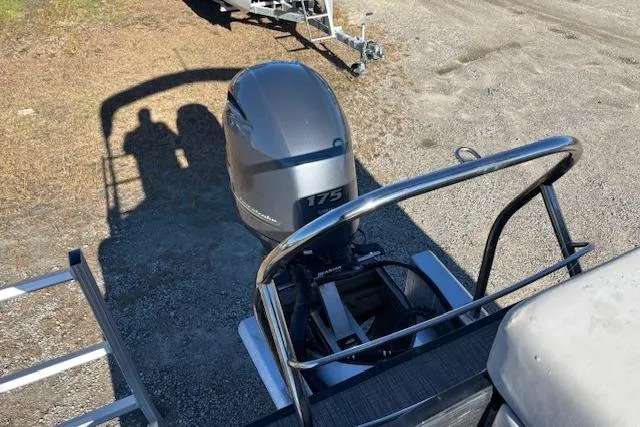 Slide: The Image of 2022 Sweetwater 2286 boat with 175 horsepower outboard motor, parked on gravel. - 19