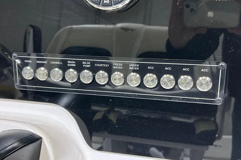Slide: The Image of Control panel of 2024 Tidewater 198 CC Adventure boat with labeled switches. - 14