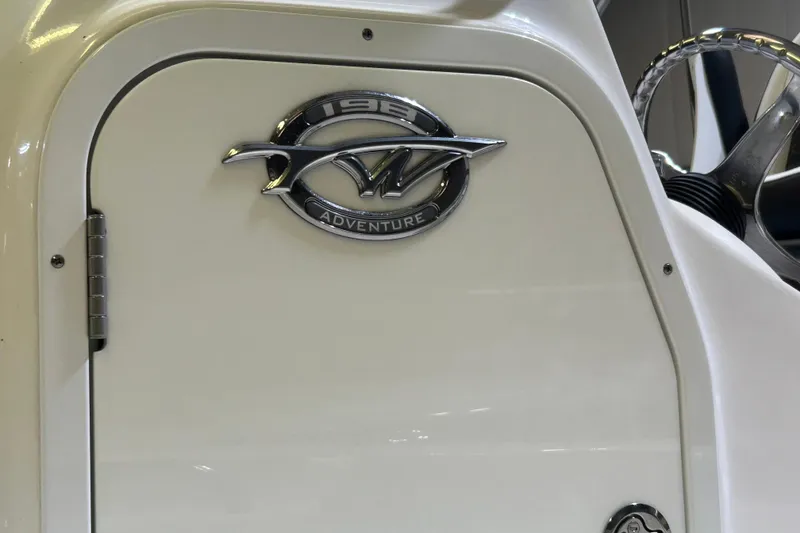 Slide: The Image of 2024 Tidewater 198 CC Adventure boat emblem and steering wheel detail. - 15