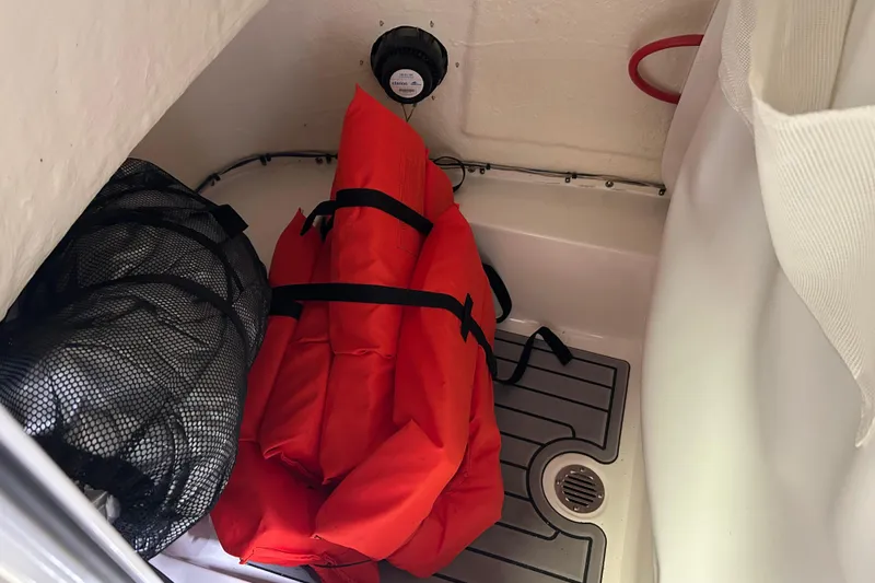 Slide: The Image of Storage compartment in 2024 Tidewater 198 CC Adventure boat with life jackets and gear. - 16