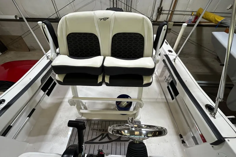 Slide: The Image of 2024 Tidewater 198 CC Adventure boat interior with dual seats and steering wheel. - 18