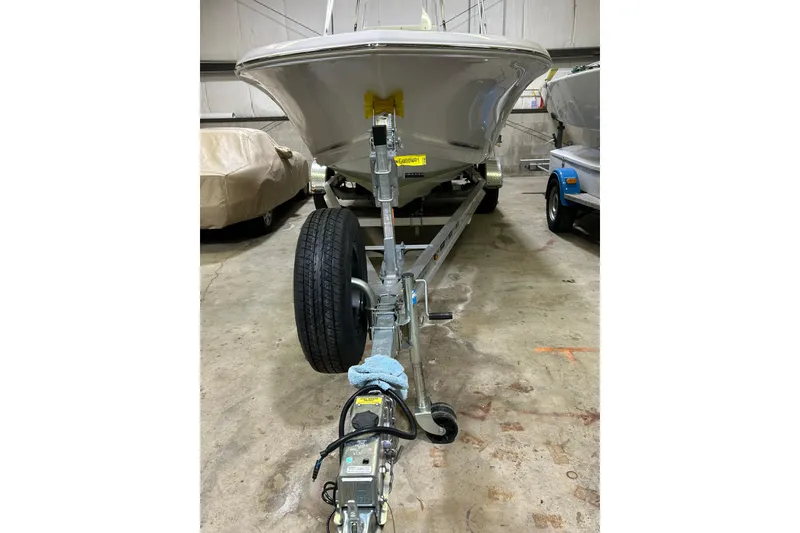 Slide: The Image of 2024 Tidewater 198 CC Adventure boat on trailer in storage facility. - 2