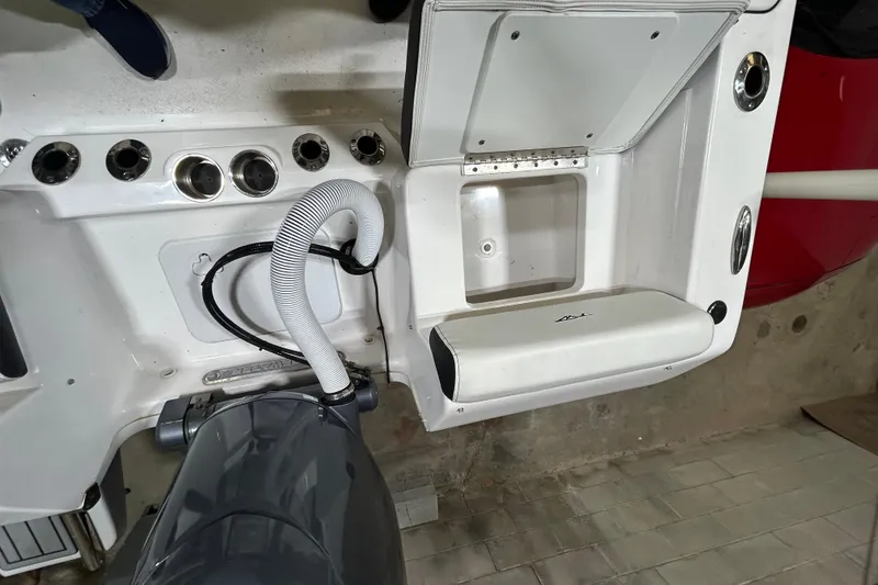 Slide: The Image of 2024 Tidewater 198 CC Adventure boat interior with engine and storage compartment. - 22