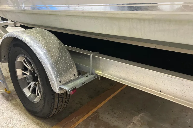 Slide: The Image of Trailer wheel and fender of 2024 Tidewater 198 CC Adventure boat. - 24