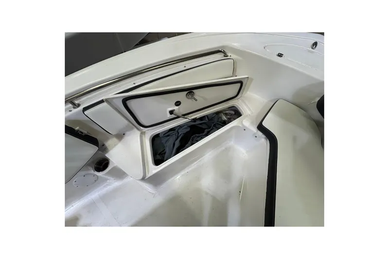Slide: The Image of 2024 Tidewater 198 CC Adventure boat storage compartment open, showcasing interior space. - 8