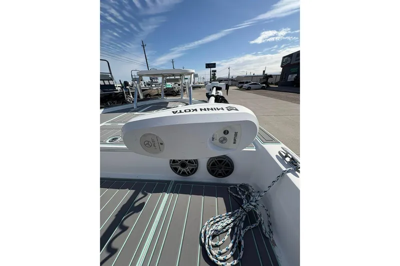 Slide: The Image of 2020 Shallow Sport 24 Sport boat on trailer, featuring teal and white design. - 2