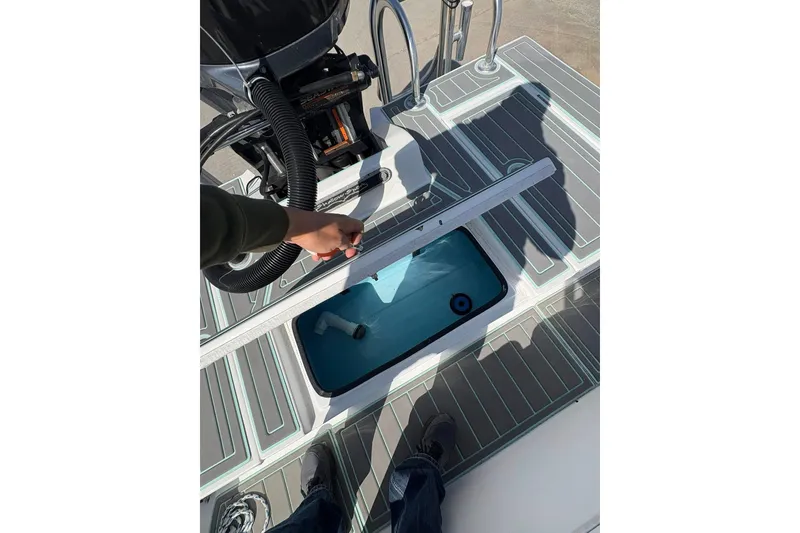 Slide: The Image of 2020 Shallow Sport 24 Sport boat on trailer at dealership, featuring teal and white design. - 3
