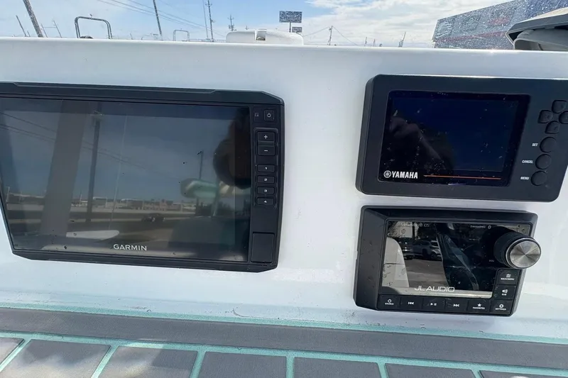 Slide: The Image of 2020 Shallow Sport 24 Sport boat interior with striped seating and deck view. - 7