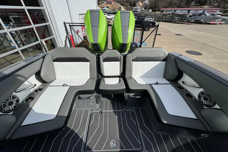 Slide: The Image of 2026 Sunsation 32 CCX boat interior with stylish seating and vibrant green engines. - 11