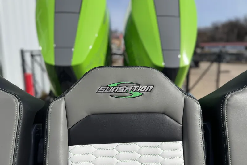 Slide: The Image of 2026 Sunsation 32 CCX boat seat with logo, featuring green and gray design. - 12