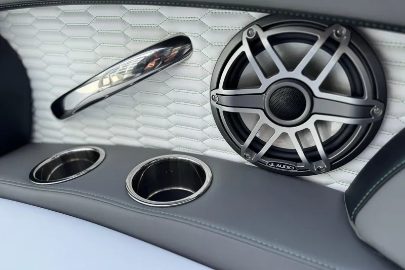 Slide: The Image of 2026 Sunsation 32 CCX interior with JL Audio speaker and cup holders. - 13