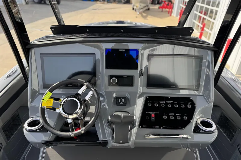 Slide: The Image of 2026 Sunsation 32 CCX boat dashboard with dual screens and modern controls. - 15
