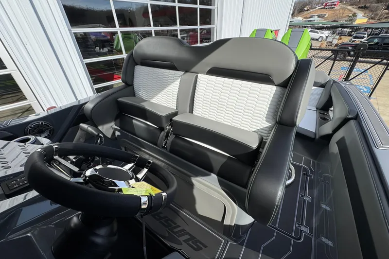 Slide: The Image of 2026 Sunsation 32 CCX boat interior with sleek steering wheel and modern seating design. - 16